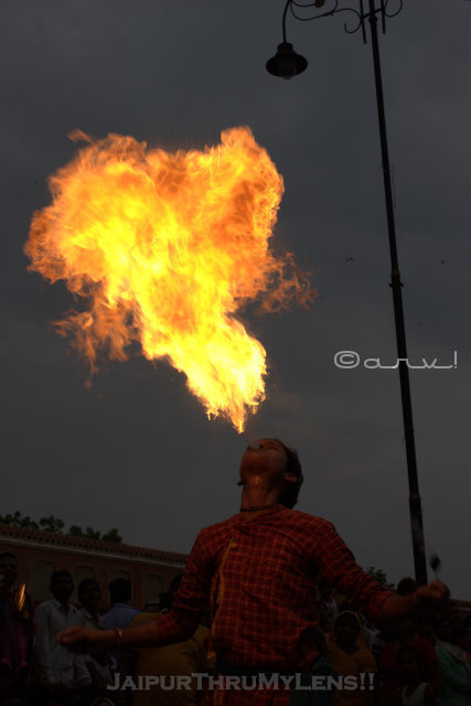 man-blowing-flame-jaipur-teej-festival