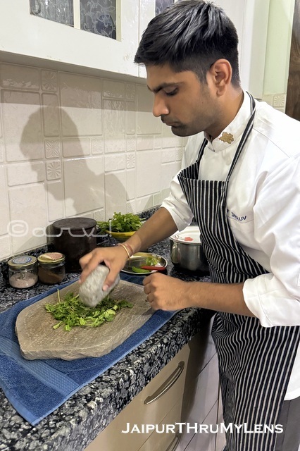 A trained professional chef preparing traditional Rajasthani dishes during a home cooking class in Jaipur